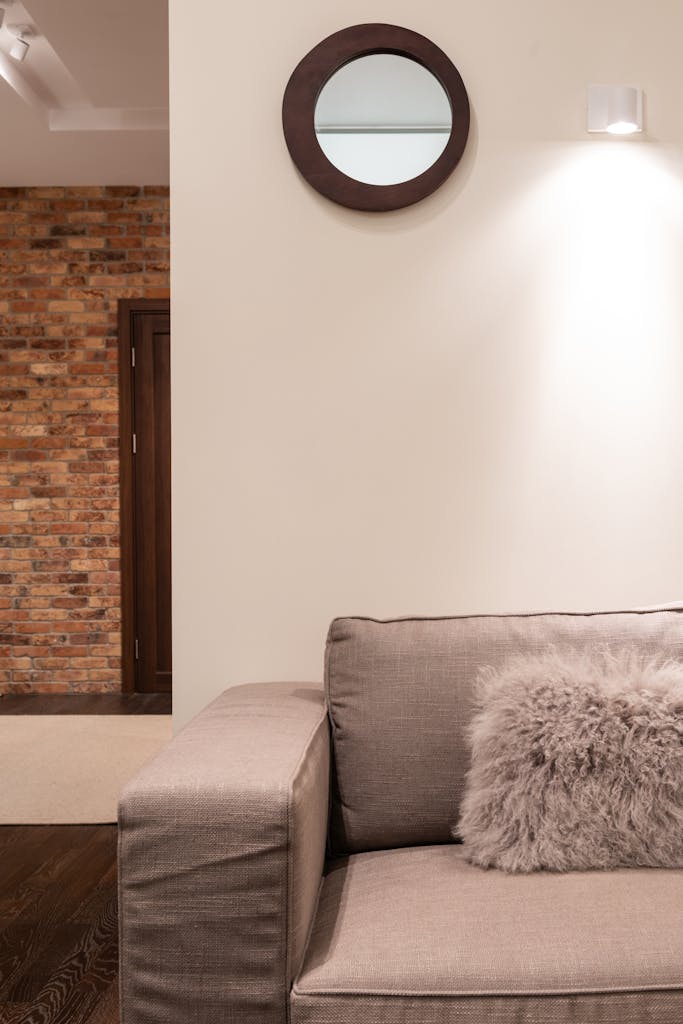 Cozy minimalist living room with plush beige sofa and decorative elements in a modern setting.