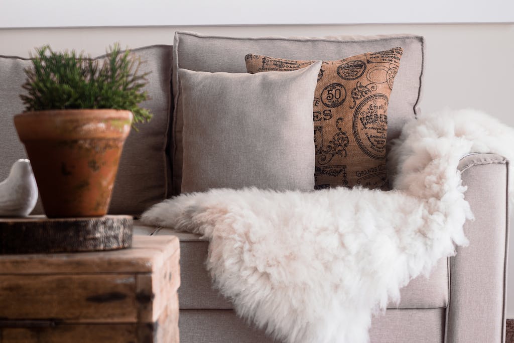 velvet cushions and plush throw on small sofa